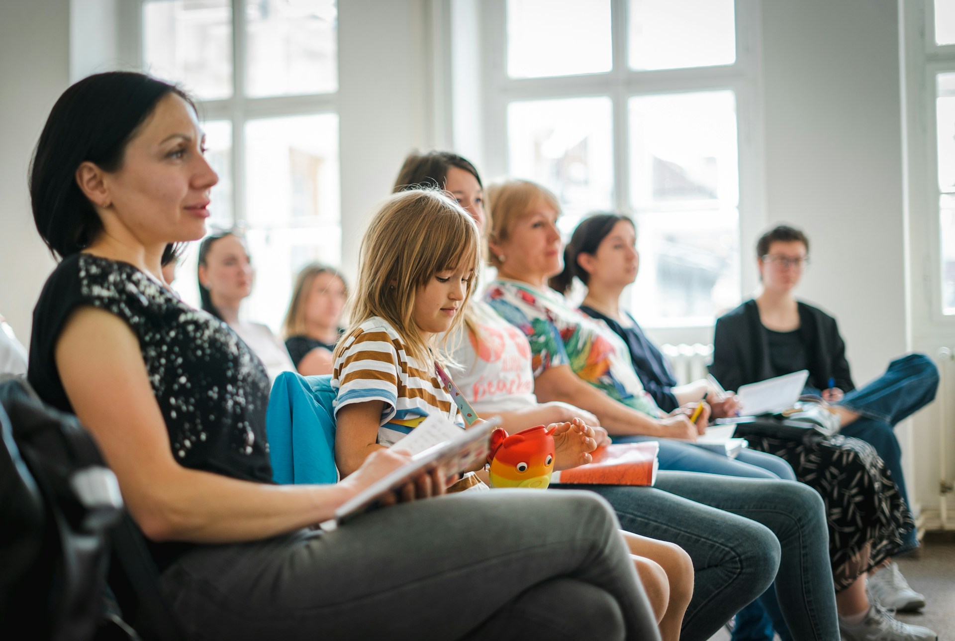 timur-shakerzianov-RfIywtE7jHQ-unsplash People sitting in meeting with diverse crowd