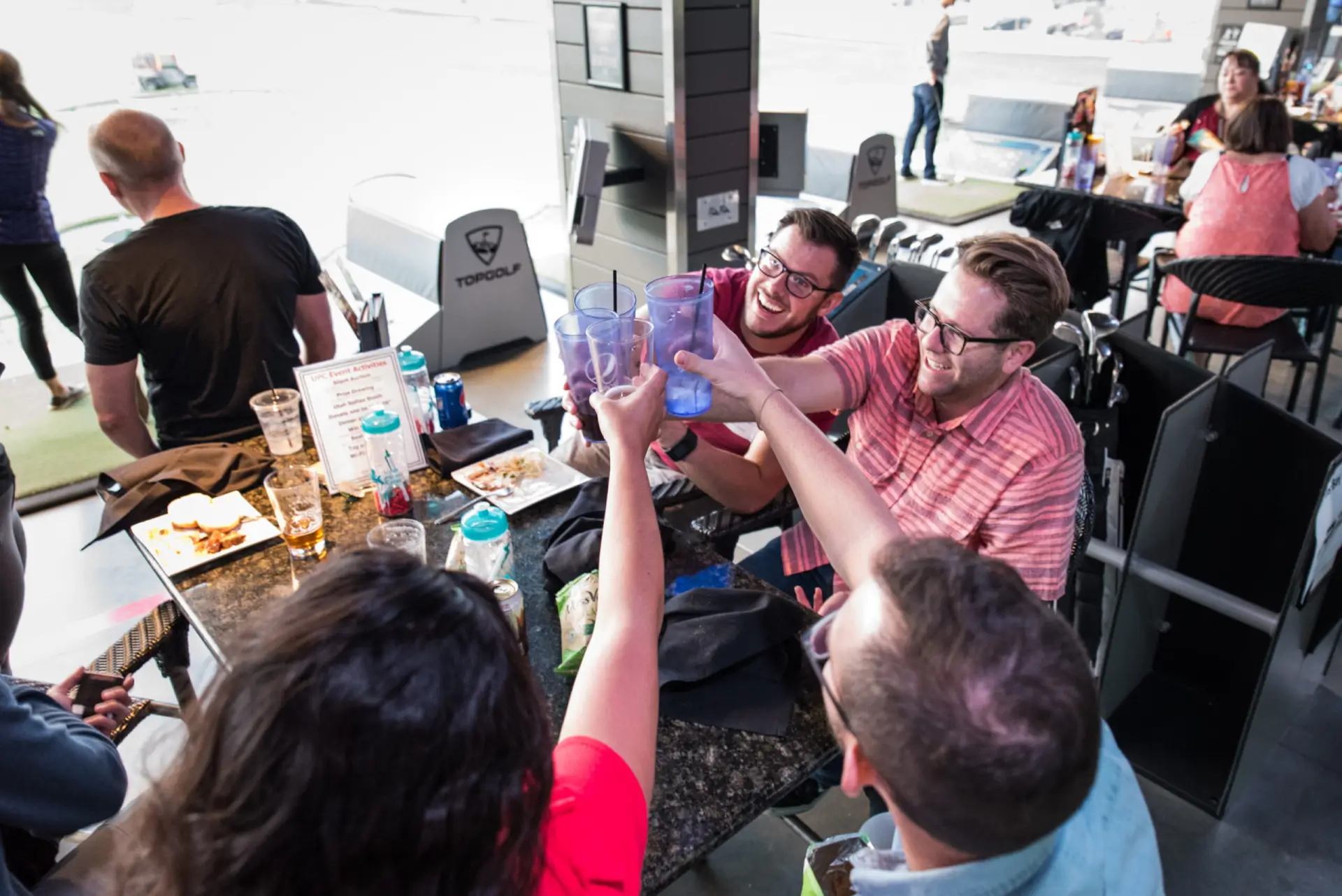 Guests celebrating together at a Utah Parent Center Topgolf event